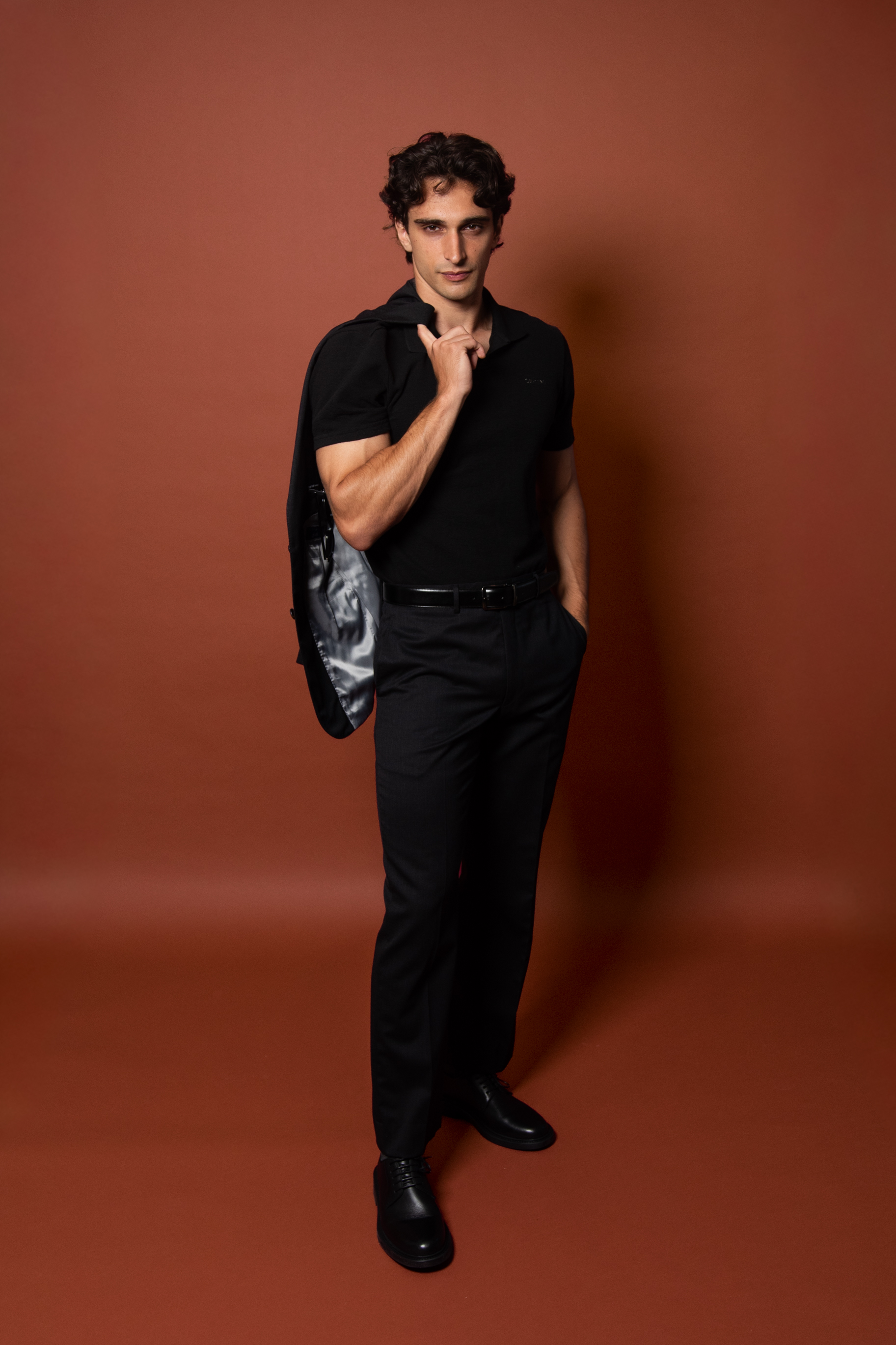 Fullbody dark suit on brown background